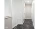Hallway with tiled floor, white trim, and louvered closet doors at 221 Eastern Ave, Indianapolis, IN 46201