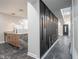 Hallway leading from open-concept living space to front door with black accent wall at 221 Eastern Ave, Indianapolis, IN 46201