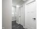 Hallway with dark grey floors, white doors, and window with natural light at 221 Eastern Ave, Indianapolis, IN 46201