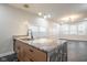 Kitchen island with marble countertops and modern pendant lighting overlooks an open-concept living area at 221 Eastern Ave, Indianapolis, IN 46201