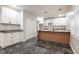 Bright kitchen features updated cabinets, granite countertops, tile backsplash and marble-look flooring at 221 Eastern Ave, Indianapolis, IN 46201