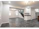 Open-concept living room featuring modern lighting, staircase access, and additional kitchen space at 221 Eastern Ave, Indianapolis, IN 46201