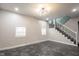 Open-concept living room with modern lighting, staircase, and marble-style flooring at 221 Eastern Ave, Indianapolis, IN 46201