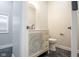 Powder room featuring decorative vanity with ornate mirror, black accents, and marble-look floors at 221 Eastern Ave, Indianapolis, IN 46201