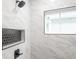 Bathroom shower with a large window, modern shower head and black honeycomb tiled niche at 221 Eastern Ave, Indianapolis, IN 46201