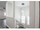 Modern staircase with chandelier lighting and decorative iron railings at 221 Eastern Ave, Indianapolis, IN 46201
