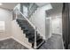 Modern staircase design with dark steps, white risers, and decorative iron railing at 221 Eastern Ave, Indianapolis, IN 46201