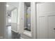 View of the water heater closet and the surrounding hallway with marbled floors at 221 Eastern Ave, Indianapolis, IN 46201