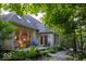 Charming backyard patio with colorful chairs and a walkway surrounded by lush greenery at 23219 Marin Dr, Cicero, IN 46034