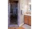 Bathroom with glass enclosed shower and wooden vanity at 23219 Marin Dr, Cicero, IN 46034