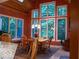 Sunlit dining area enhanced by large windows, wood ceiling, and adjacent living space for gatherings at 23219 Marin Dr, Cicero, IN 46034