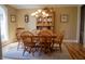 Inviting dining room features a wooden table, chairs, display cabinet and a window for natural light at 23219 Marin Dr, Cicero, IN 46034