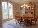 Cozy dining room features a light fixture, wooden table, chairs and a window providing ample natural light at 23219 Marin Dr, Cicero, IN 46034