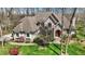 Beautiful stone and brick home with lush landscaping and mature trees at 23219 Marin Dr, Cicero, IN 46034