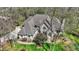 Beautiful stone and brick home with lush landscaping and mature trees at 23219 Marin Dr, Cicero, IN 46034