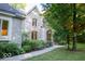 Beautiful exterior view of home with stone facade, arched entryway, landscaped pathway, and mature trees at 23219 Marin Dr, Cicero, IN 46034