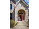 Inviting front entrance with a red door, brick archway, and a cozy rocking chair at 23219 Marin Dr, Cicero, IN 46034
