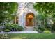 Inviting home with a wood door, stone archway, and lush green landscaping at 23219 Marin Dr, Cicero, IN 46034