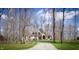 Picturesque home nestled among mature trees, featuring a stone facade and a long, winding driveway at 23219 Marin Dr, Cicero, IN 46034