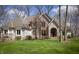 Stunning home boasts a lush green lawn, mature trees, and a welcoming front entrance with an arched doorway at 23219 Marin Dr, Cicero, IN 46034