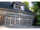 Attached three-car garage featuring neutral doors and a brick exterior at 23219 Marin Dr, Cicero, IN 46034