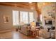 Spacious living room with wood floors, large windows, stone fireplace, and comfortable seating area at 23219 Marin Dr, Cicero, IN 46034