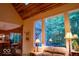 Cozy living area with wood ceiling, comfortable seating, and bright windows with a view of the backyard at 23219 Marin Dr, Cicero, IN 46034