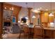 Open-concept design showcasing a stone fireplace and view to the kitchen with bar stool seating at 23219 Marin Dr, Cicero, IN 46034