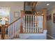 Staircase with white railing, wooden banister, and carpeted steps at 23219 Marin Dr, Cicero, IN 46034