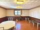Spacious dining room with wood-paneled walls and a large window at 243 E Benton St, Alexandria, IN 46001