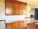 An eat-in kitchen features lots of wooden cabinets, and laminate countertops at 243 E Benton St, Alexandria, IN 46001