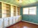 A home office includes many built-in shelves and storage cabinets at 243 E Benton St, Alexandria, IN 46001