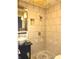 An updated shower features tile walls, a glass enclosed shower, and a stylish sink at 243 E Benton St, Alexandria, IN 46001