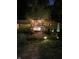Night view of backyard pool and deck, illuminated gazebo, and landscape lighting at 251 E South St, Franklin, IN 46131