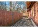 The backyard features an exterior brick wall with string lights and a wooden fence for privacy at 251 E South St, Franklin, IN 46131