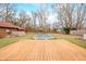 Inviting backyard featuring a pristine wooden deck, lush lawn, gazebo, mature trees, and partially covered pool, perfect for outdoor gatherings at 251 E South St, Franklin, IN 46131