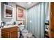 Bathroom with a wood vanity, updated shower, toilet, and window at 251 E South St, Franklin, IN 46131