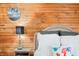 Cozy bedroom detail with a wood paneled wall and home sweet home decor at 251 E South St, Franklin, IN 46131