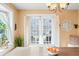 Bright dining area with large windows and a view, complemented by an elegant chandelier at 251 E South St, Franklin, IN 46131