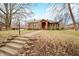Landscaped front yard with a charming brick home featuring a welcoming entrance and mature trees at 251 E South St, Franklin, IN 46131