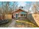 Charming brick outbuilding with a green striped awning, walkway, and meticulously maintained landscaping, creating a welcoming exterior at 251 E South St, Franklin, IN 46131