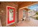 Cozy front porch featuring a red door, tiled flooring and seating area at 251 E South St, Franklin, IN 46131