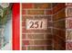 Close-up of the house number 251 displayed on a decorative tile next to the front door at 251 E South St, Franklin, IN 46131