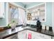 Lovely kitchen featuring a granite countertop, white shelves, and stainless steel sink under the window at 251 E South St, Franklin, IN 46131