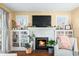 Living room with a brick fireplace, built-in bookshelves, and hardwood floors at 251 E South St, Franklin, IN 46131