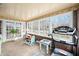 Bright sunroom filled with natural light, brick walls, and cozy furnishings at 251 E South St, Franklin, IN 46131