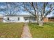 Charming one-story home with a white brick exterior and a well-maintained front yard at 3024 N Huber St, Indianapolis, IN 46226