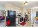 Functional kitchen with an adjoining living space, a black refrigerator and essential appliances at 3024 N Huber St, Indianapolis, IN 46226