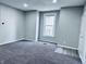A gray bedroom with a window and a gray carpet at 310 N Monroe St, Muncie, IN 47305