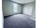 Newly carpeted bedroom featuring neutral paint and a bright window at 310 N Monroe St, Muncie, IN 47305